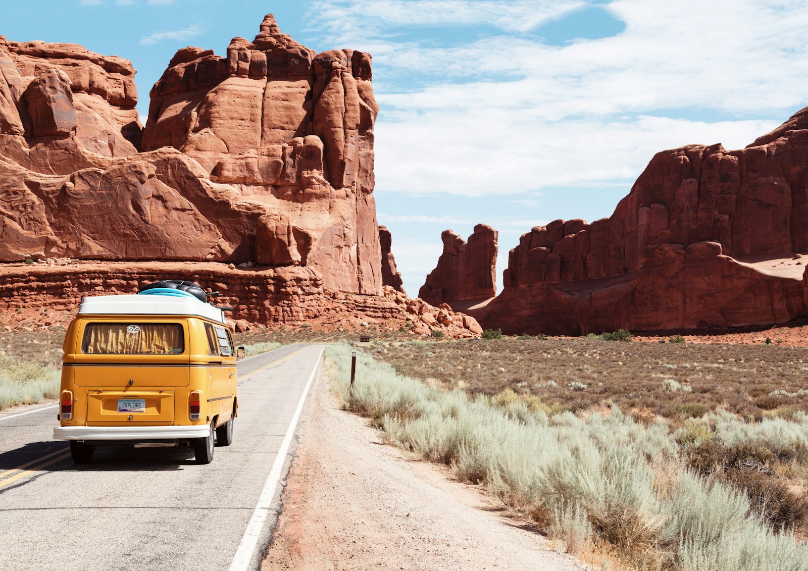 Open road through vivid hills at dusk